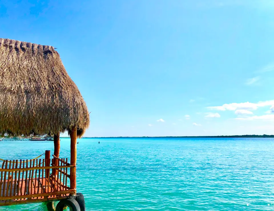 thatch hut above the sea during day — Bacalar