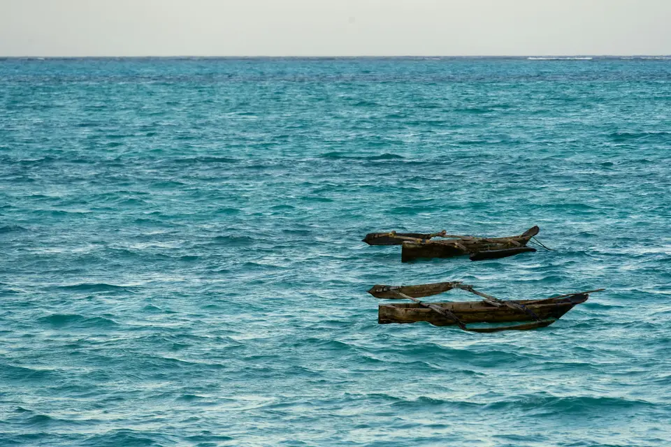 a couple of boats floating on top of a large body of water — Cozumel