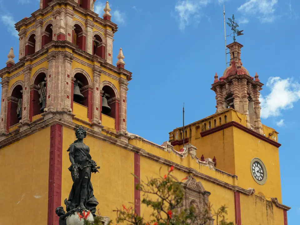 A tall yellow building with a clock on it's side — Guanajuato