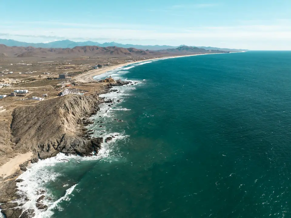 an aerial view of a beach and the ocean — Los Cabos