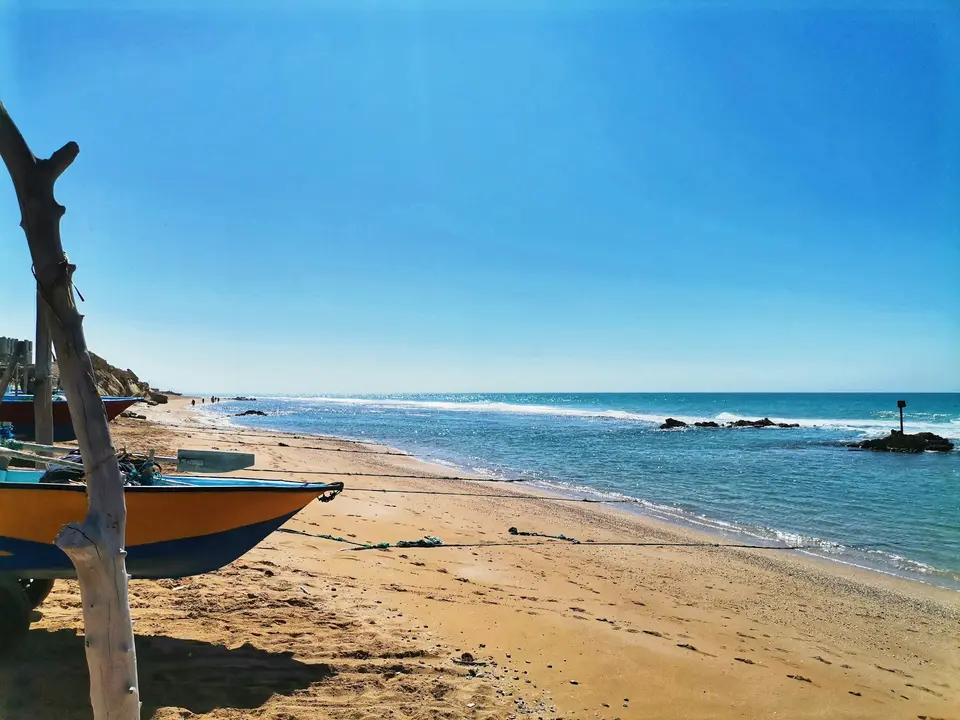 A boat sitting on top of a sandy beach — Playa del Carmen
