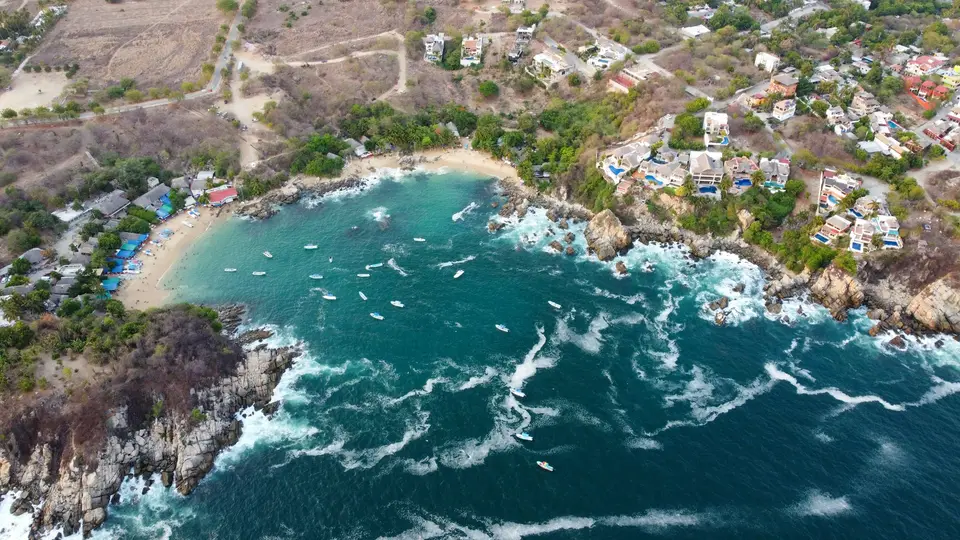 a bird's eye view of the ocean and a small town — Puerto Escondido