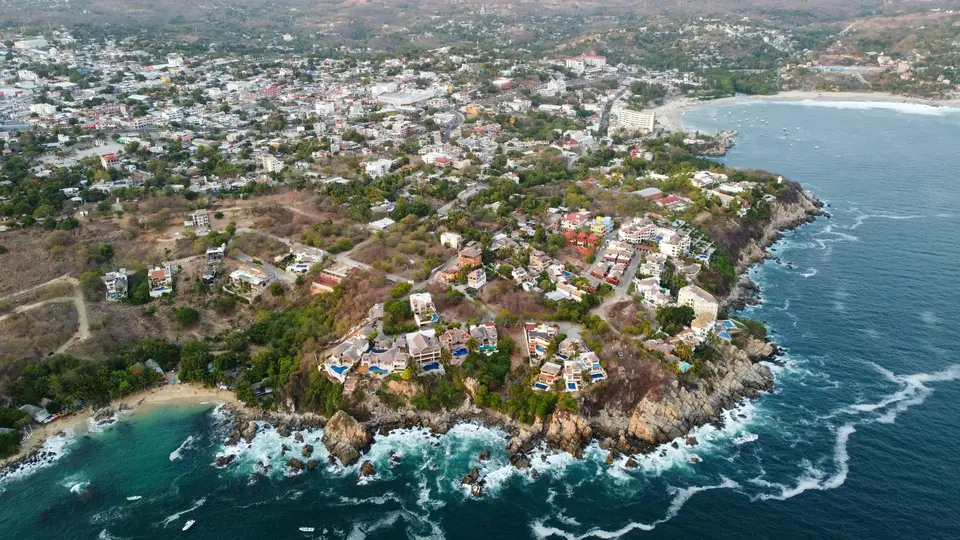 an aerial view of a small island in the middle of the ocean — Puerto Escondido