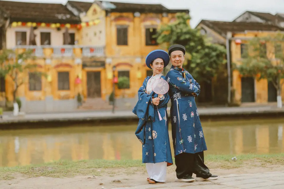 Couple in traditional vietnamese clothing by river